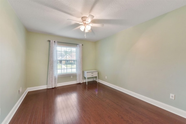 empty room featuring dark wood-style floors, a textured ceiling, baseboards, and a ceiling fan