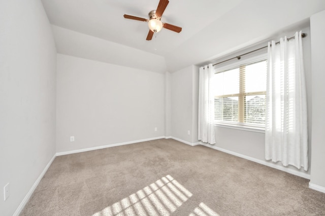 unfurnished room featuring ceiling fan, baseboards, vaulted ceiling, and carpet flooring