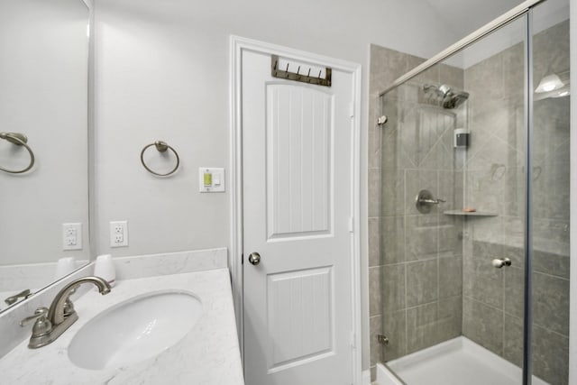 full bathroom with a shower stall and vanity