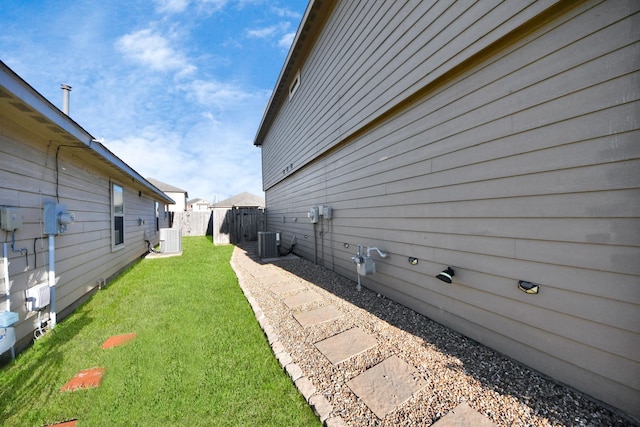 exterior space featuring fence and central AC unit