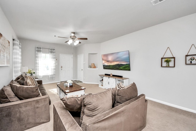 living room with light carpet, ceiling fan, and baseboards