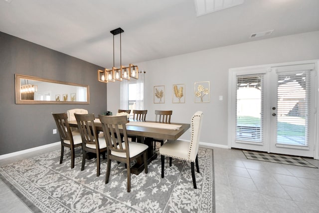 tiled dining area featuring visible vents and baseboards