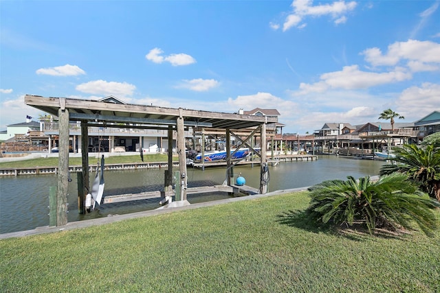 view of dock featuring a water view, boat lift, and a lawn