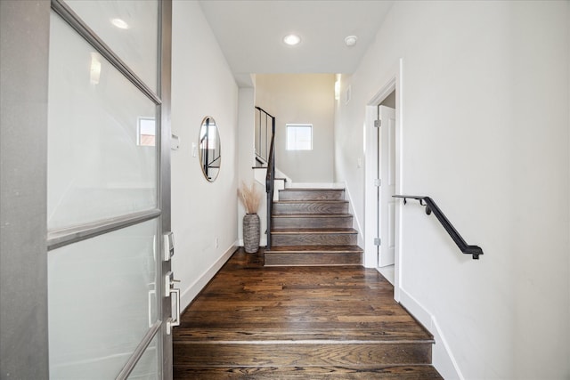 staircase with recessed lighting, wood finished floors, and baseboards