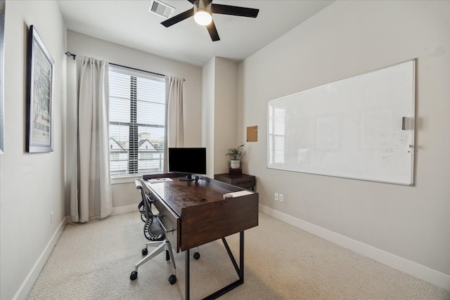 office area with baseboards, a ceiling fan, visible vents, and light colored carpet