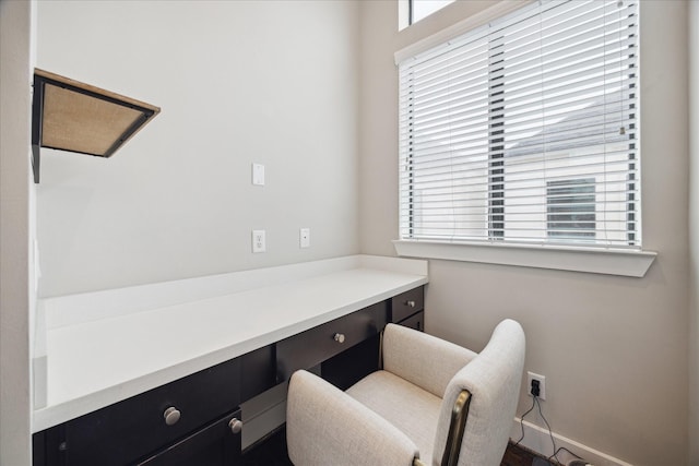 office featuring built in study area and baseboards