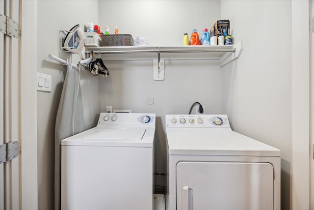 washroom featuring laundry area and separate washer and dryer