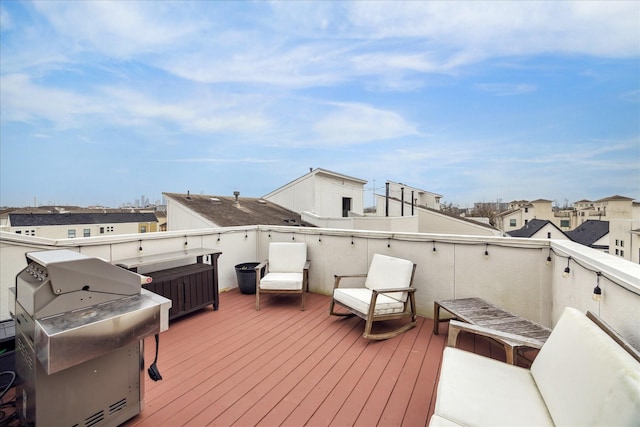 deck with a grill and a residential view