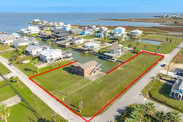 drone / aerial view featuring a water view and a residential view