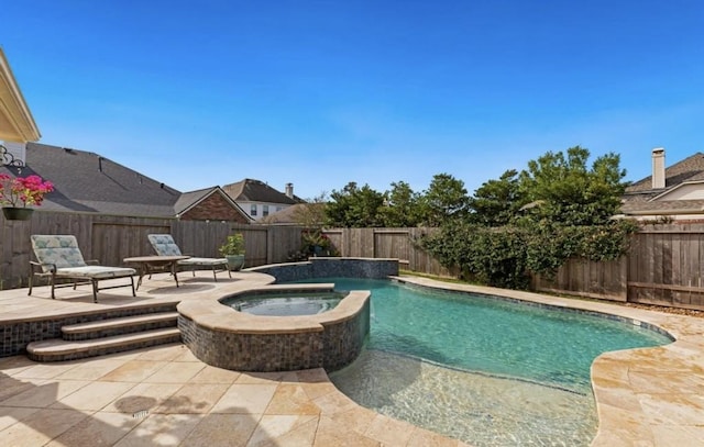 view of swimming pool with a patio area, a fenced backyard, and a pool with connected hot tub