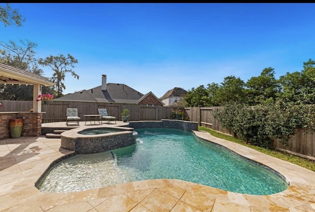 view of pool featuring a patio area, a fenced backyard, and a pool with connected hot tub