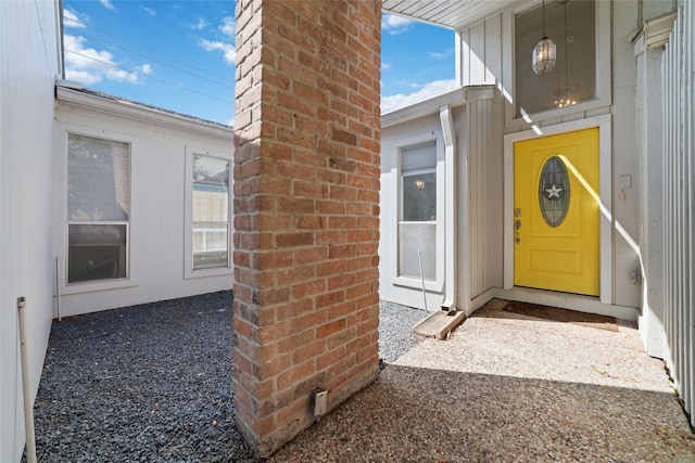 view of exterior entry with a chimney