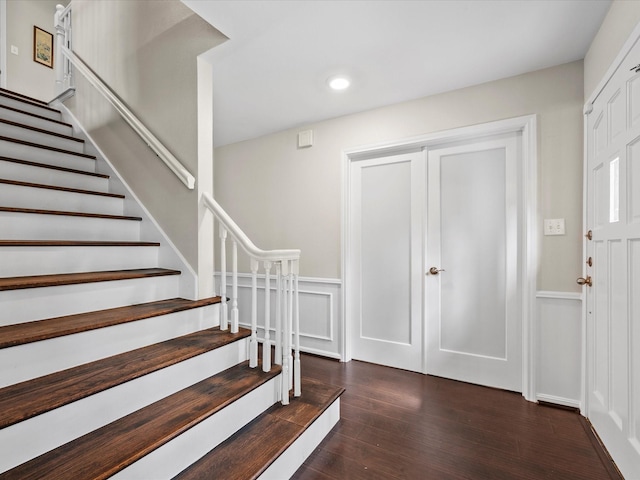 foyer entrance with recessed lighting, stairs, and wood finished floors