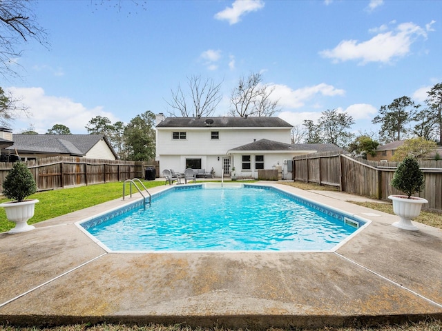 view of swimming pool featuring a fenced backyard, a patio area, a yard, and a fenced in pool