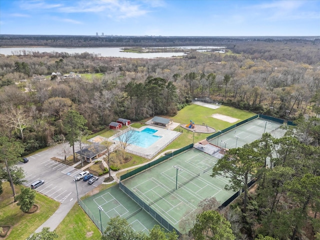 drone / aerial view with a forest view and a water view