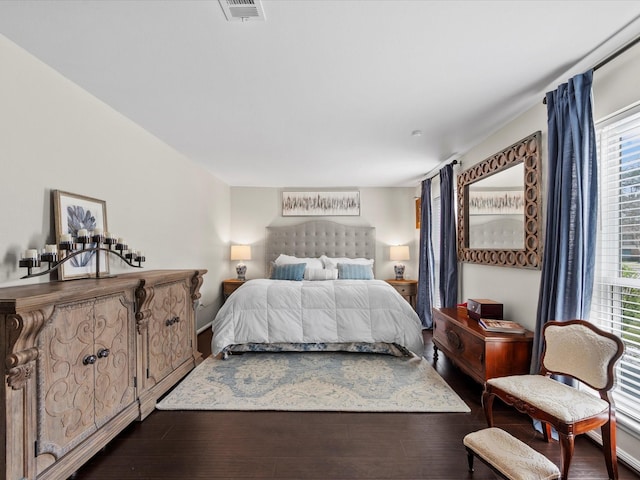 bedroom featuring visible vents and dark wood-style flooring