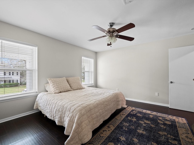 bedroom featuring dark wood-style floors, ceiling fan, and baseboards