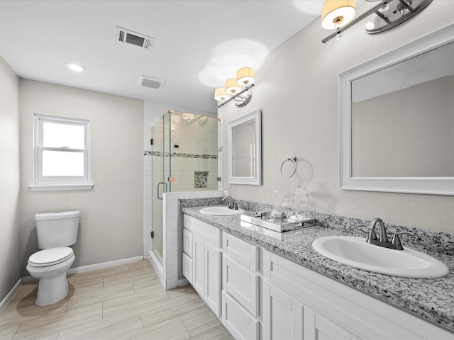 551 Hermitage Ct, Conroe, TX 77302 - bathroom featuring a stall shower, double vanity, toilet, baseboards, and recessed lighting