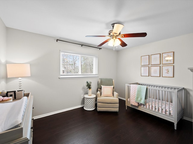 551 Hermitage Ct, Conroe, TX 77302 - bedroom with baseboards, a nursery area, wood finished floors, and ceiling fan