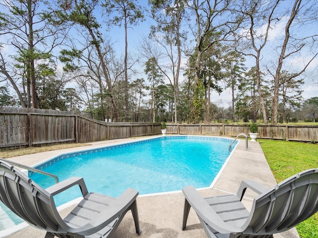 view of swimming pool with a yard, a fenced in pool, a patio, and a fenced backyard