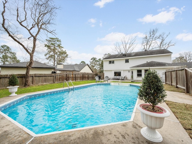 view of swimming pool with a patio, a fenced in pool, a lawn, and a fenced backyard