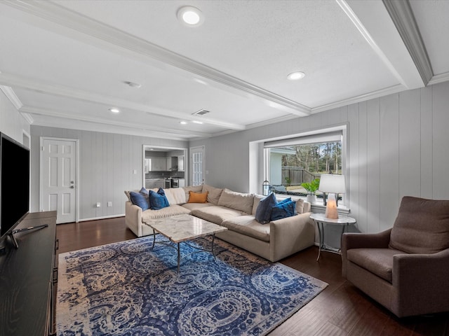 living room with beam ceiling, visible vents, dark wood-style flooring, and ornamental molding