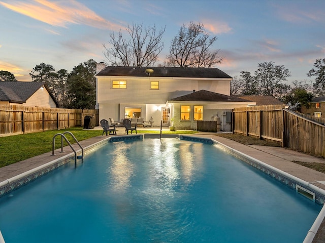 view of swimming pool featuring a patio, a fenced in pool, a yard, a fenced backyard, and an outdoor hangout area