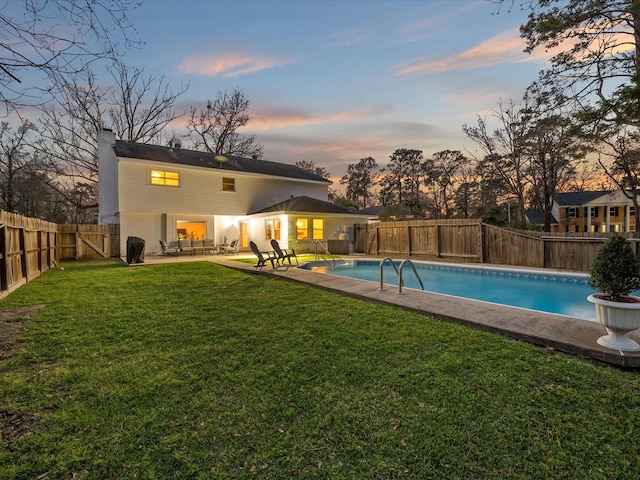 view of swimming pool with a fenced backyard, a fenced in pool, a patio, and a yard