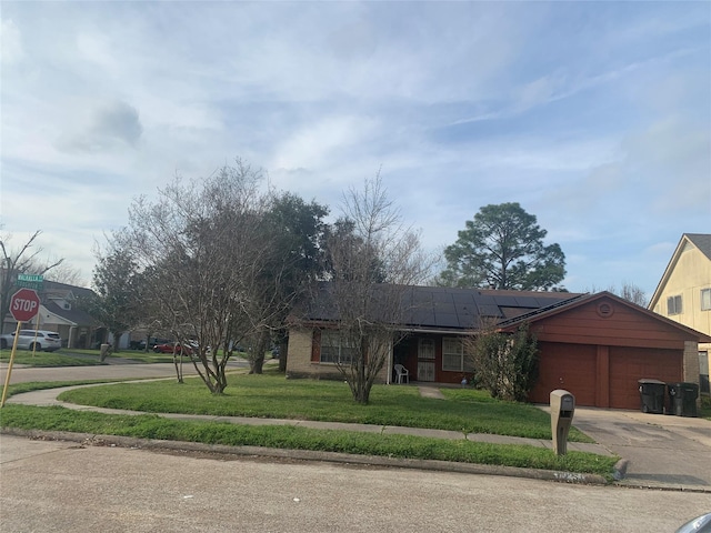 ranch-style house featuring an attached garage, driveway, a front lawn, and brick siding