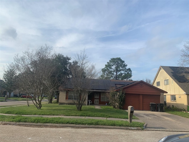 single story home with a front yard, brick siding, driveway, and an attached garage