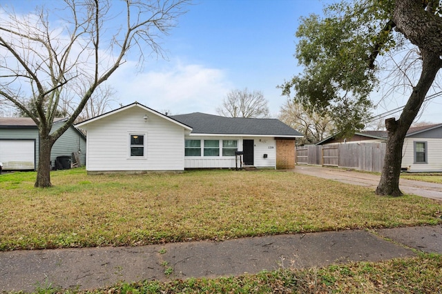 ranch-style home with fence and a front yard