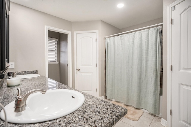 bathroom featuring double vanity, tile patterned flooring, shower / bathtub combination with curtain, and a sink