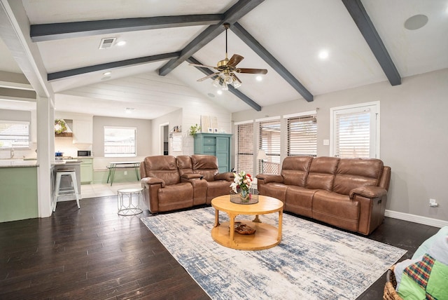 living area featuring vaulted ceiling with beams, visible vents, dark wood-type flooring, ceiling fan, and baseboards