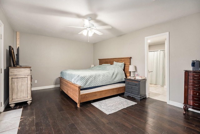 bedroom featuring hardwood / wood-style flooring, a ceiling fan, baseboards, and connected bathroom