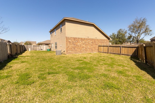 exterior space with central AC unit and a fenced backyard