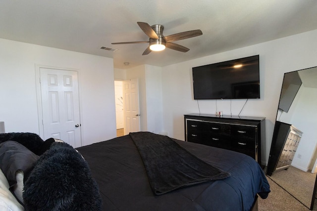 carpeted bedroom with visible vents and ceiling fan