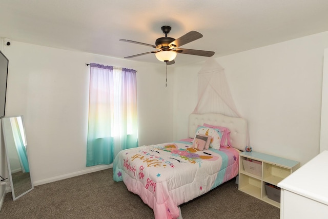 carpeted bedroom featuring baseboards and a ceiling fan