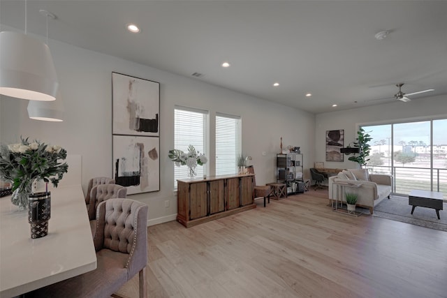 interior space featuring recessed lighting, visible vents, light wood-style flooring, a ceiling fan, and baseboards