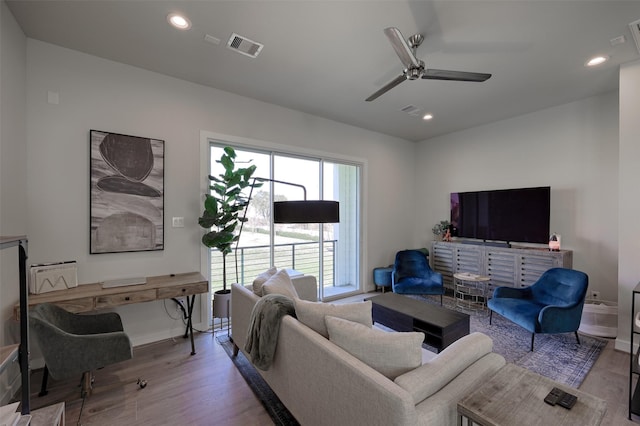 living room with recessed lighting, visible vents, ceiling fan, and wood finished floors