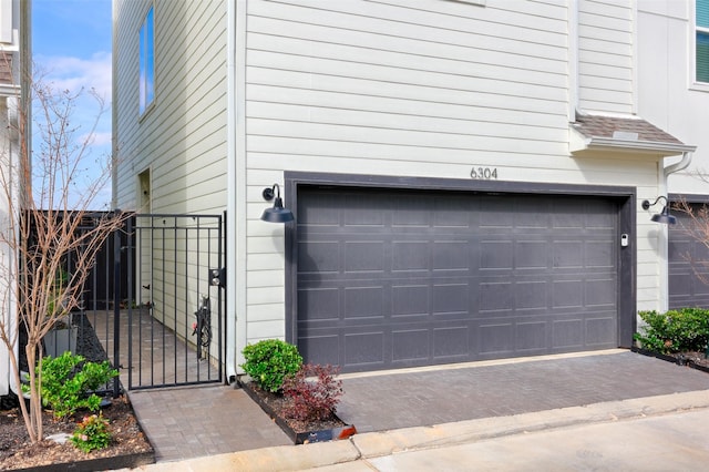 garage featuring a gate and fence