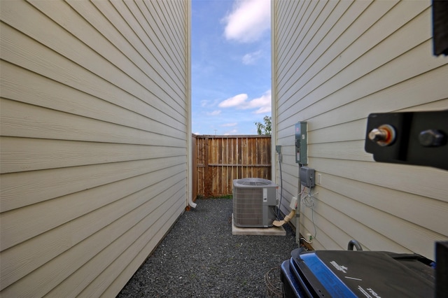 view of side of property with cooling unit and fence