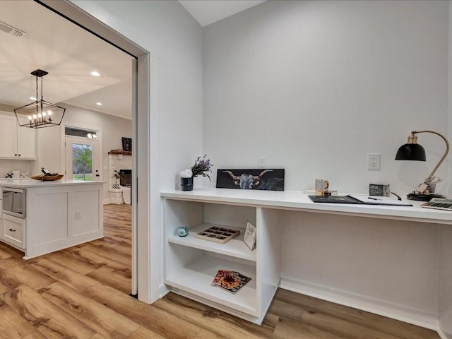 interior space with light wood finished floors, visible vents, and recessed lighting