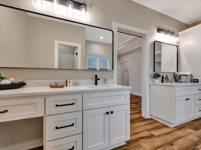 bathroom featuring wood finished floors, vanity, and baseboards