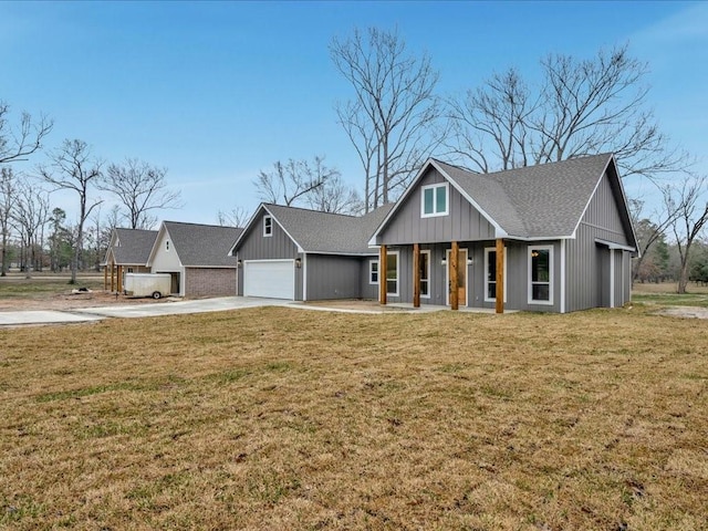 view of front of house with a garage, covered porch, concrete driveway, and a front yard