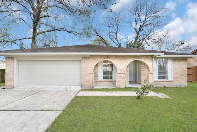 view of front of property featuring a front yard, concrete driveway, brick siding, and an attached garage