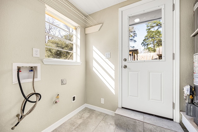 laundry room featuring washer hookup, a textured wall, hookup for an electric dryer, laundry area, and baseboards