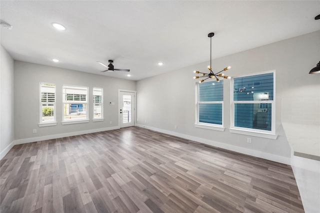 unfurnished living room featuring baseboards, wood finished floors, and recessed lighting