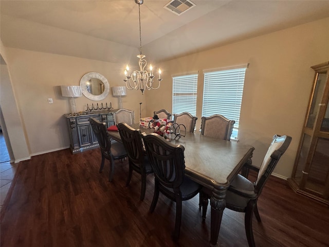 dining room with dark wood-style floors, baseboards, visible vents, and a notable chandelier