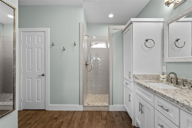 22318 Vista Del Mar, Galveston, TX 77554 - full bath with a tile shower, vanity, baseboards, and wood finish floors