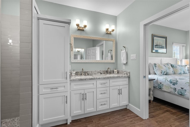 22318 Vista Del Mar, Galveston, TX 77554 - ensuite bathroom featuring double vanity, a sink, connected bathroom, and wood finished floors